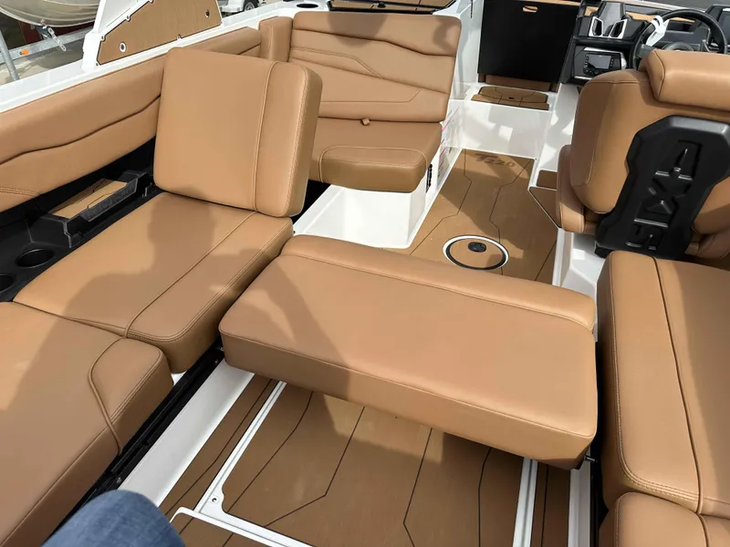 Slide: The Image of Luxurious tan interior of 2025 Axis T220 boat with comfortable seating and modern design. - 10