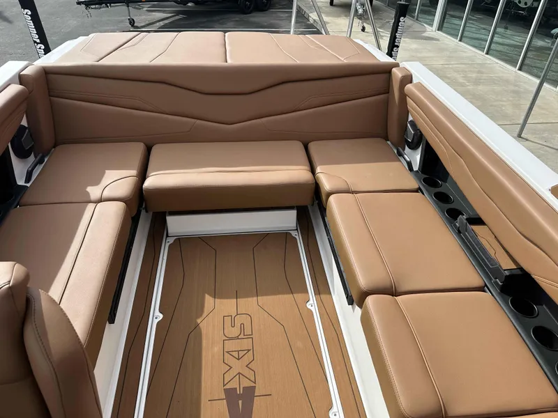 Slide: The Image of 2025 Axis T220 boat interior with tan leather seating and cup holders. - 11