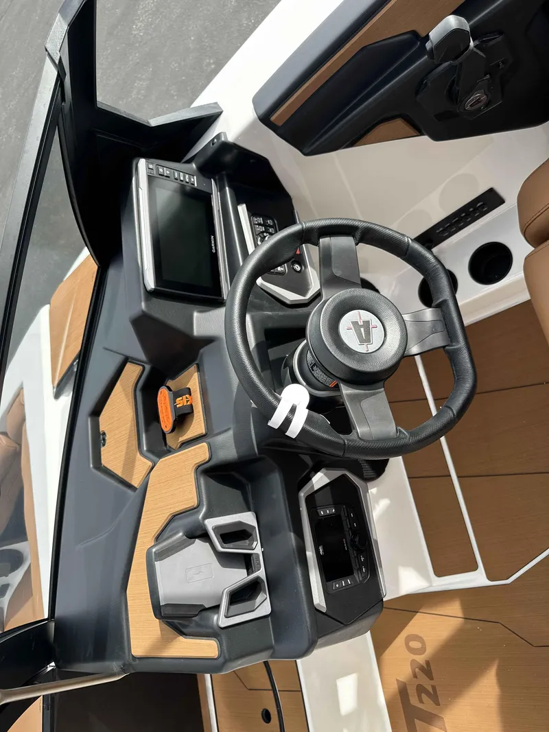 Slide: The Image of 2025 Axis T220 boat dashboard with steering wheel and control panel. - 7