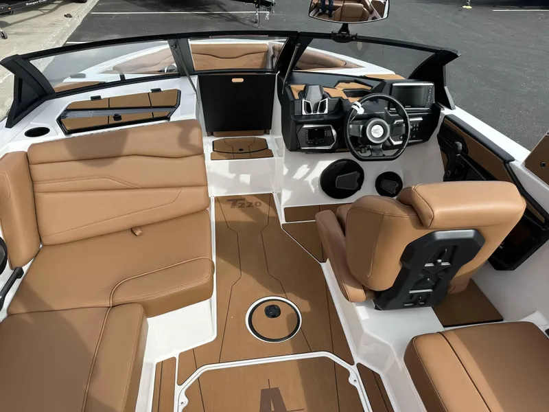 Slide: The Image of 2025 Axis T220 boat interior with tan leather seats and modern dashboard. - 8