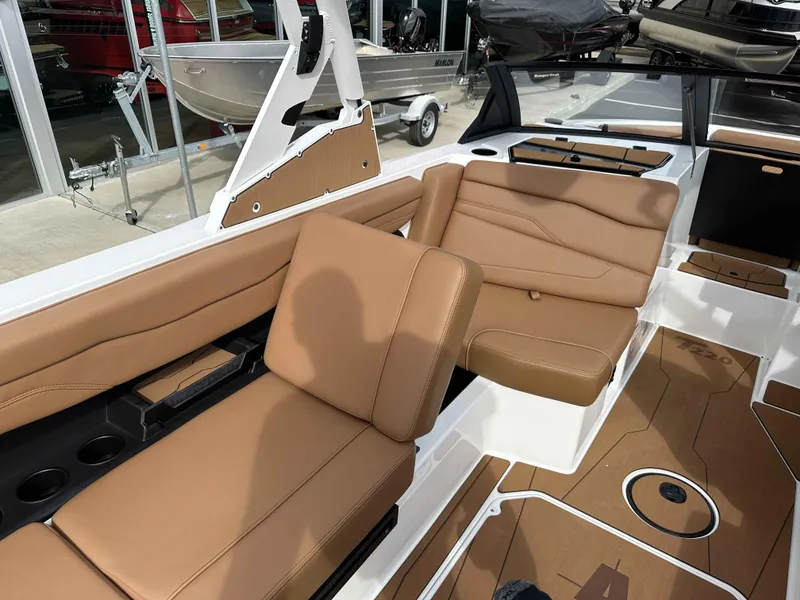 Slide: The Image of 2025 Axis T220 boat interior with tan leather seating and modern design. - 9