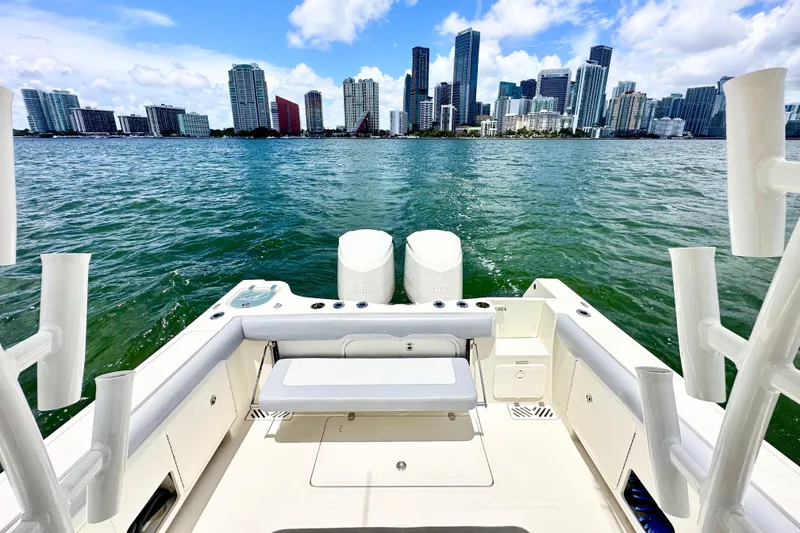 Slide: The Image of 2014 Sailfish 320 CC boat with city skyline in the background. - 11