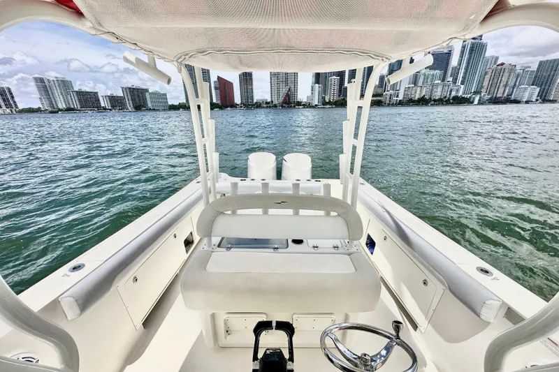 Slide: The Image of 2014 Sailfish 320 CC boat interior with city skyline in the background. - 12