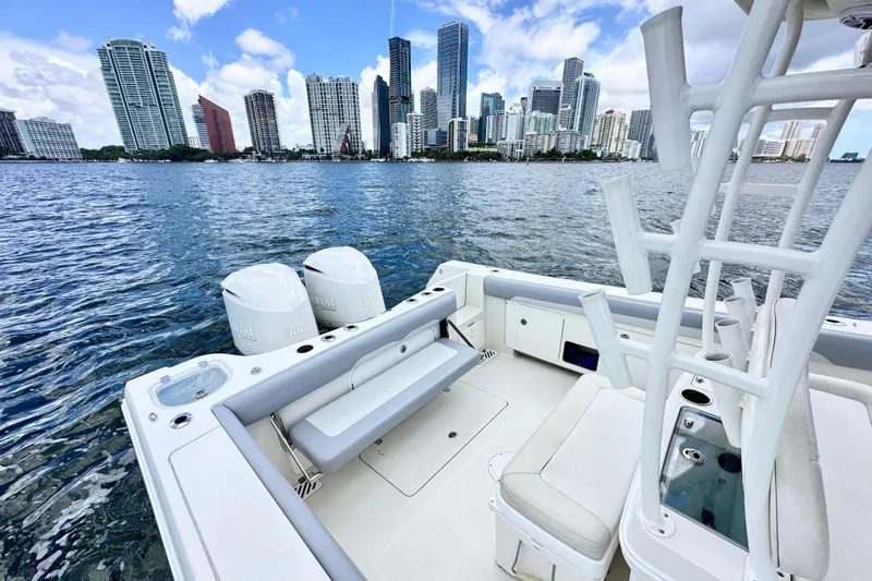 Slide: The Image of 2014 Sailfish 320 CC boat with city skyline in the background. - 9