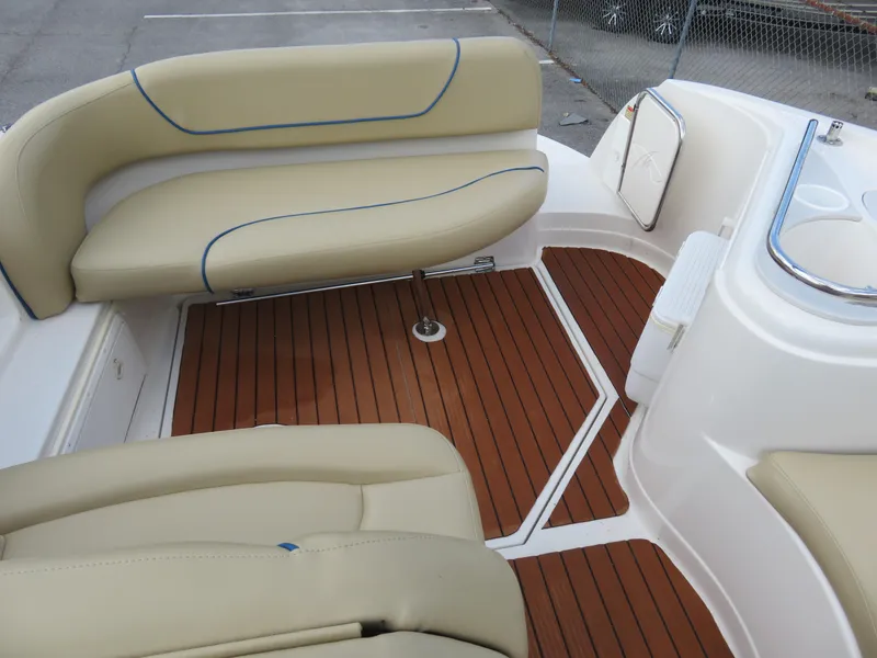 Slide: The Image of 2004 Monterey 245 Cruiser interior with beige seating and wood-style flooring. - 4