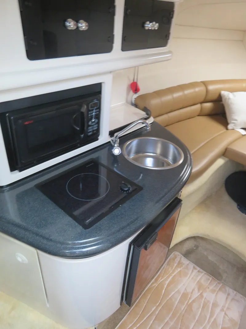 Slide: The Image of 2004 Monterey 245 Cruiser interior with kitchenette and seating area. - 8