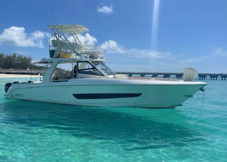 The Image of 2016 Boston Whaler 420 Outrage boat on clear turquoise water under blue sky. - 0