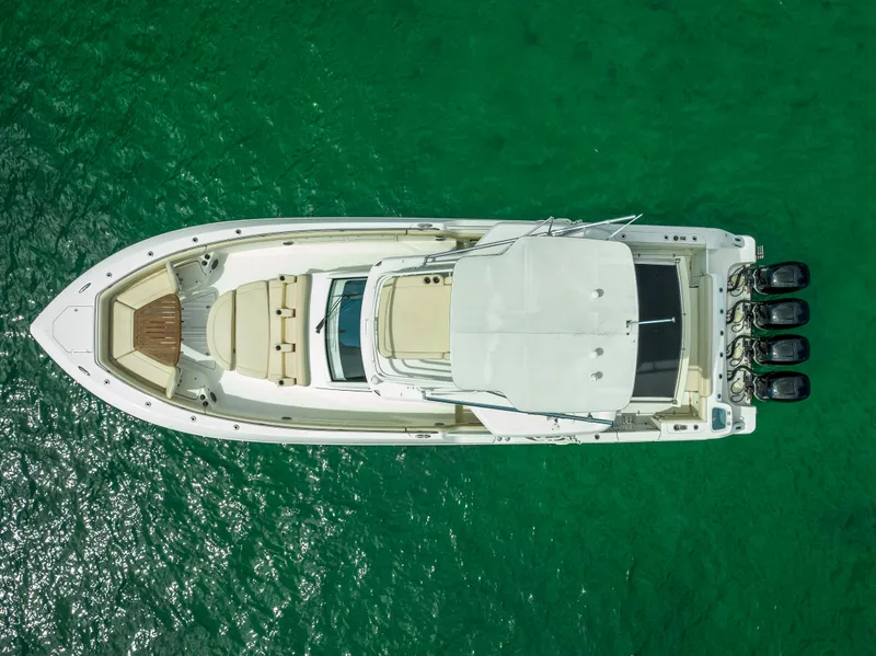 Slide: The Image of Top view of 2016 Boston Whaler 420 Outrage boat on clear green water. - 6
