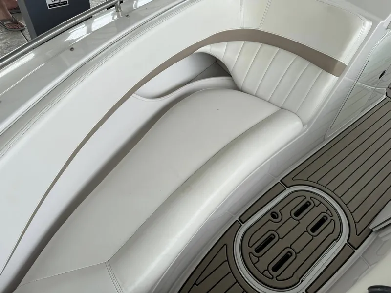 Slide: The Image of 2006 Four Winns 290 Horizon boat interior with white seating and teak-style flooring. - 10