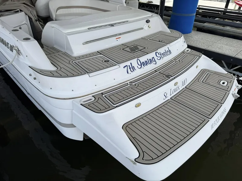 Slide: The Image of 2006 Four Winns 290 Horizon boat docked, featuring custom decking and "7th Inning Stretch" name. - 11
