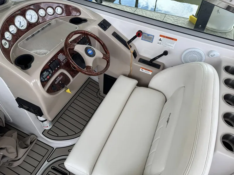 Slide: The Image of 2006 Four Winns 290 Horizon boat cockpit with steering wheel and gauges. - 13