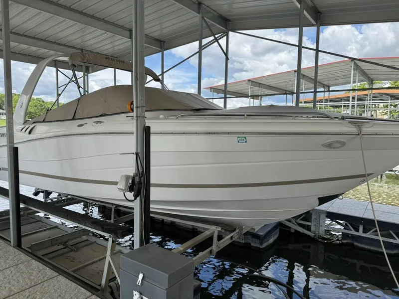 Slide: The Image of 2006 Four Winns 290 Horizon boat docked under a covered marina. - 14