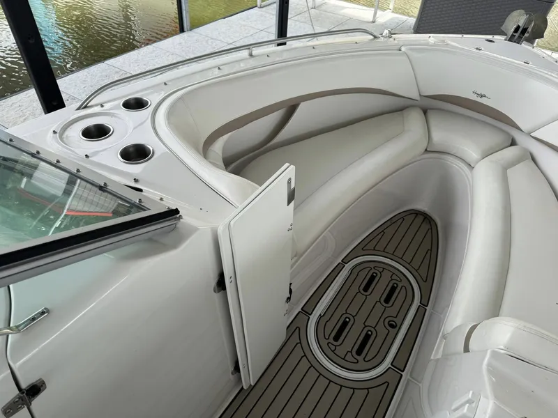 Slide: The Image of 2006 Four Winns 290 Horizon boat interior with white seating and cup holders. - 15