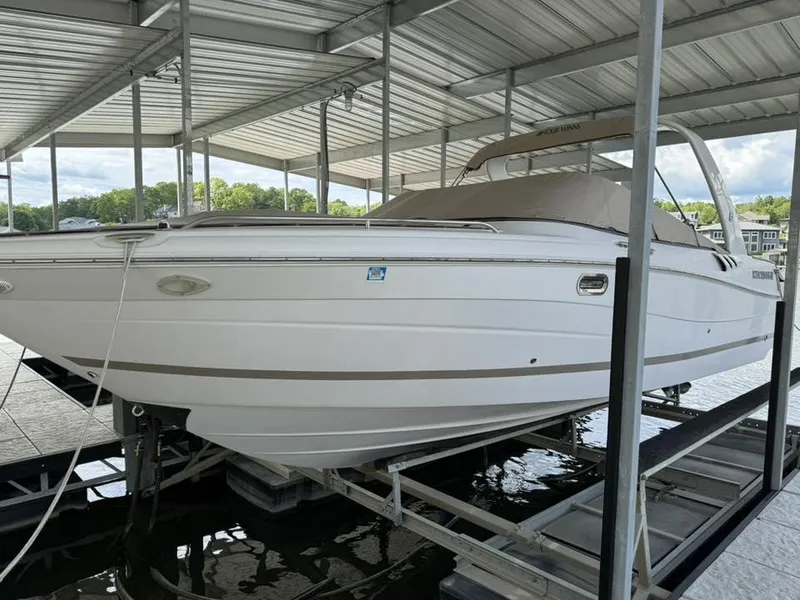 Slide: The Image of 2006 Four Winns 290 Horizon boat docked under a covered marina. - 16