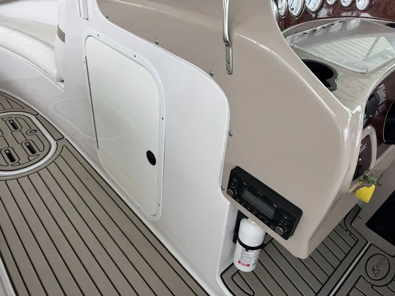 Slide: The Image of 2006 Four Winns 290 Horizon boat interior with dashboard and fire extinguisher. - 17