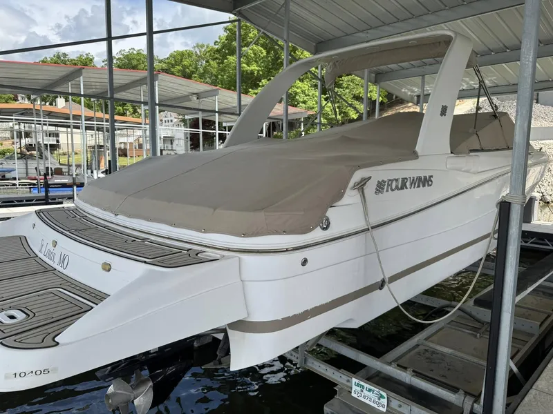 Slide: The Image of 2006 Four Winns 290 Horizon boat docked under a covered marina. - 20