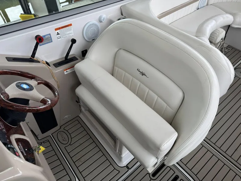 Slide: The Image of Captain's seat and steering wheel of 2006 Four Winns 290 Horizon boat interior. - 22