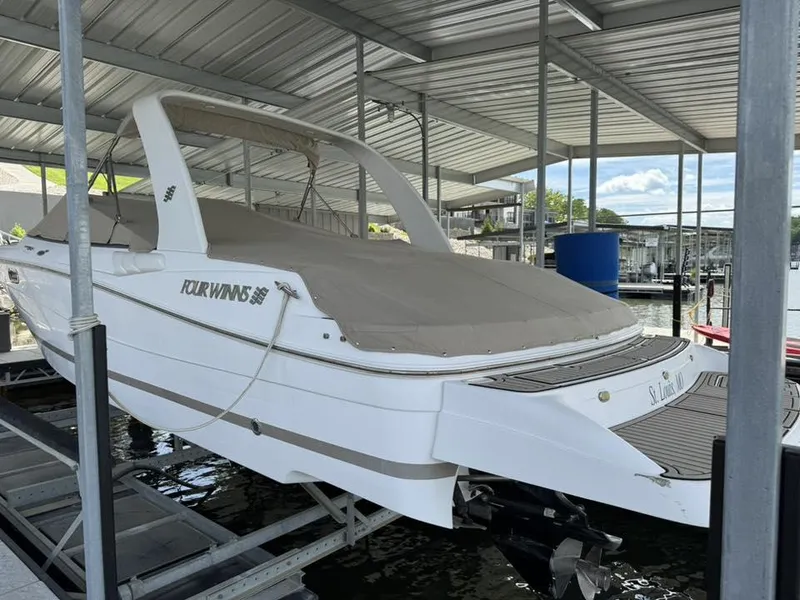 Slide: The Image of 2006 Four Winns 290 Horizon boat docked under a metal canopy. - 26
