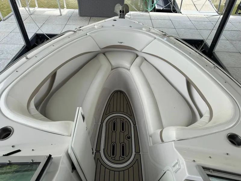 Slide: The Image of 2006 Four Winns 290 Horizon boat interior with white seating and teak flooring. - 28