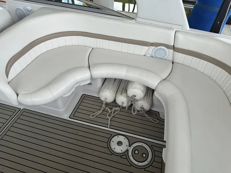 Slide: The Image of 2006 Four Winns 290 Horizon boat interior with cushioned seating and fenders stored underneath. - 3