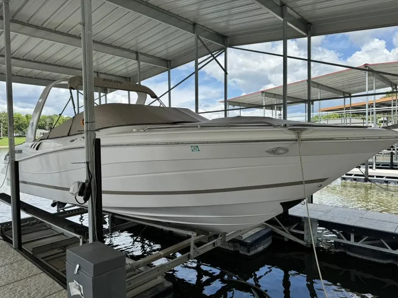 Slide: The Image of 2006 Four Winns 290 Horizon boat docked under a covered marina. - 5