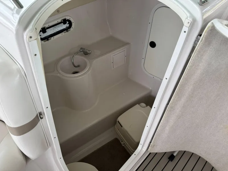 Slide: The Image of 2006 Four Winns 290 Horizon boat interior with compact bathroom and sink. - 6