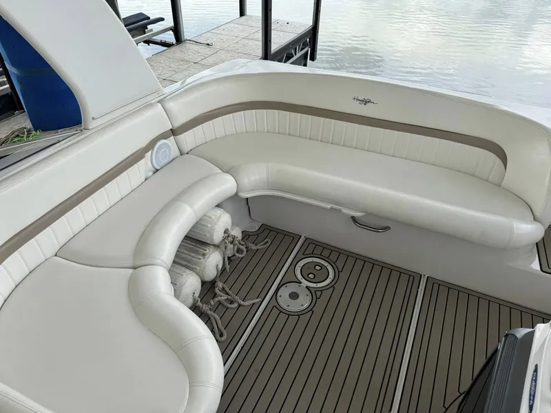 Slide: The Image of 2006 Four Winns 290 Horizon boat interior with white seating and wood-patterned flooring. - 7