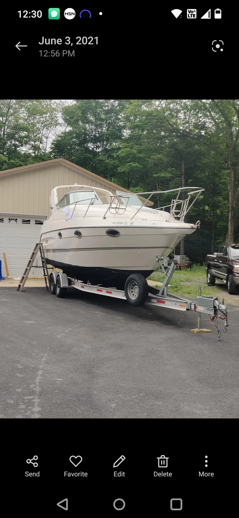 Slide: The Image of Maxum 2800 SCR 2000 boat on trailer, parked near garage, surrounded by trees. - 16