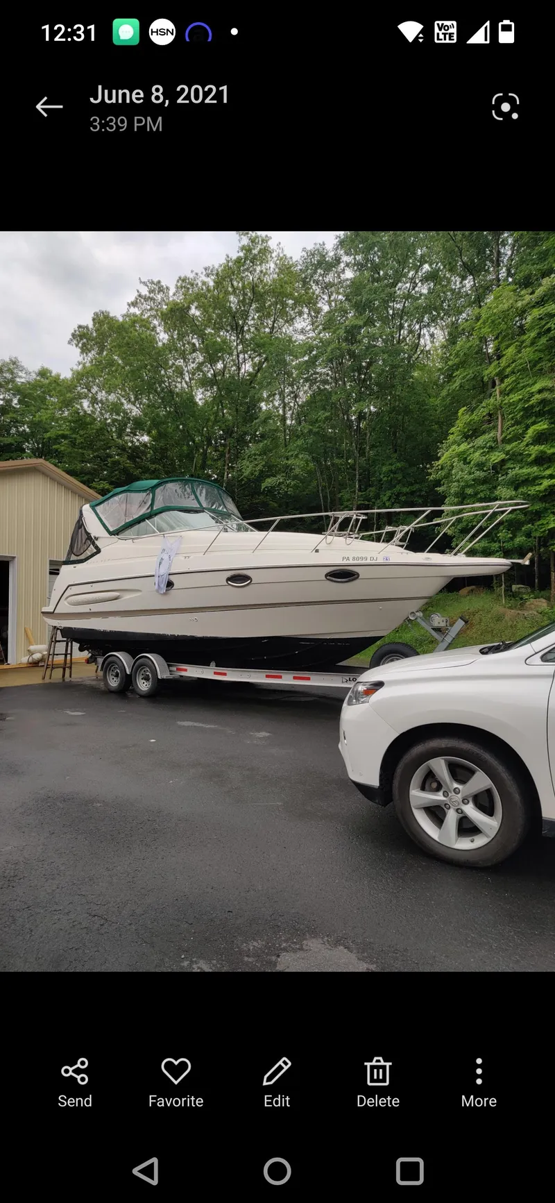 Slide: The Image of 2000 Maxum 2800 SCR boat on trailer, parked outdoors near trees and vehicles. - 18