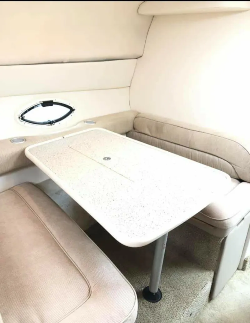 Slide: The Image of Interior of 2000 Maxum 2800 SCR boat with beige seating and table. - 22