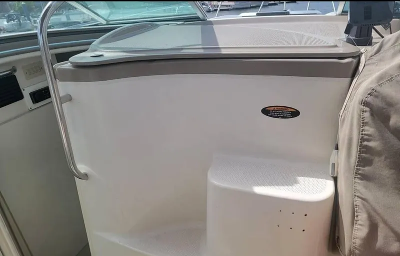 Slide: The Image of Interior view of a 2000 Maxum 2800 SCR boat, featuring a sleek design and seating area. - 4