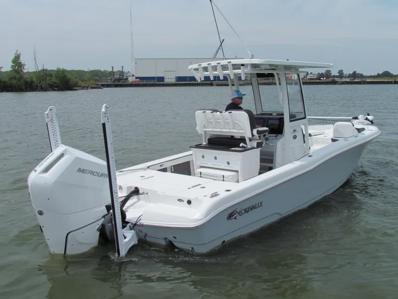 Slide: The Image of 2024 Crevalle 26 HCO boat on water, featuring a Mercury engine and sleek design. - 0