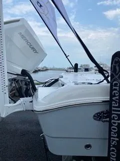 Slide: The Image of 2024 Crevalle 26 HCO boat with Mercury engine, docked by the waterfront. - 10