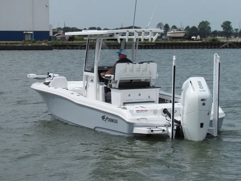 Slide: The Image of 2024 Crevalle 26 HCO boat on water, featuring sleek design and powerful outboard engine. - 11