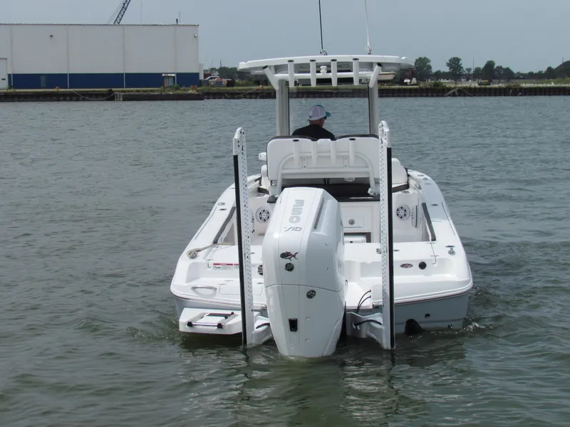Slide: The Image of 2024 Crevalle 26 HCO boat on water, rear view, with outboard motor and T-top. - 12