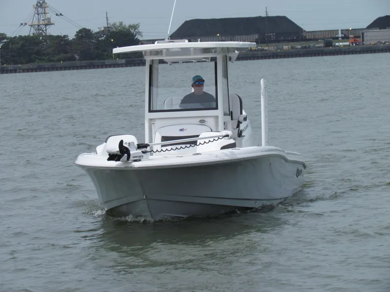 Slide: The Image of 2024 Crevalle 26 HCO boat navigating on calm waters. - 13