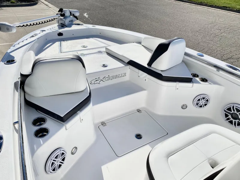 Slide: The Image of 2024 Crevalle 26 HCO boat interior with white seating and cup holders. - 16