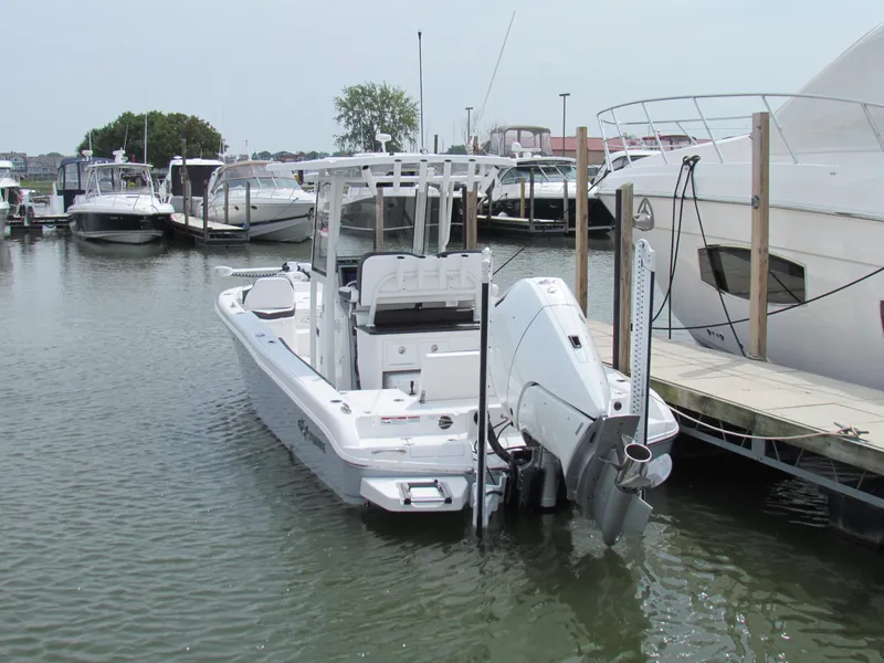 Slide: The Image of 2024 Crevalle 26 HCO boat docked in a marina, rear view. - 17