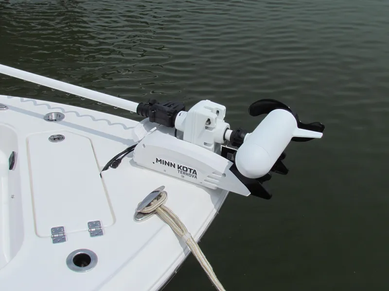Slide: The Image of 2024 Crevalle 26 HCO boat with Minn Kota trolling motor on calm water. - 2