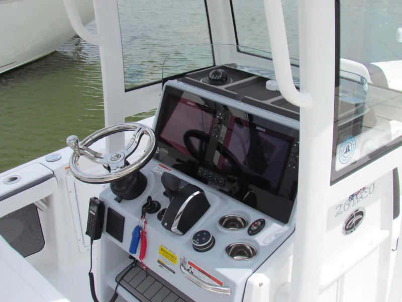 Slide: The Image of 2024 Crevalle 26 HCO boat console with steering wheel and navigation equipment. - 4