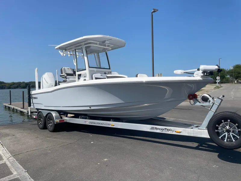 Slide: The Image of 2024 Crevalle 26 HCO boat on trailer at a boat launch under clear blue sky. - 7