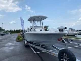 Slide: The Image of 2024 Crevalle 26 HCO boat on trailer in parking lot, under cloudy sky. - 9