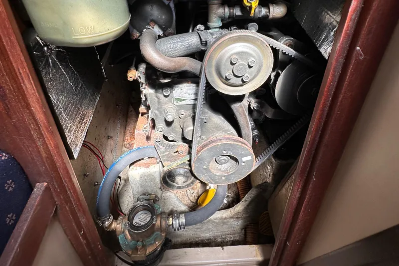 Slide: The Image of Engine compartment of a 1987 C&C 34 sailboat, showing belts and hoses. - 15