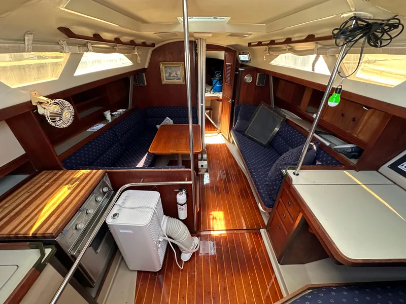 Slide: The Image of Interior of a 1987 C&C 34 sailboat with wood finishes and seating area. - 9