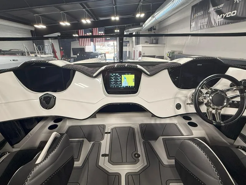 Slide: The Image of Interior of a 2016 Daves Custom Boats M31, featuring a sleek dashboard and modern controls. - 10
