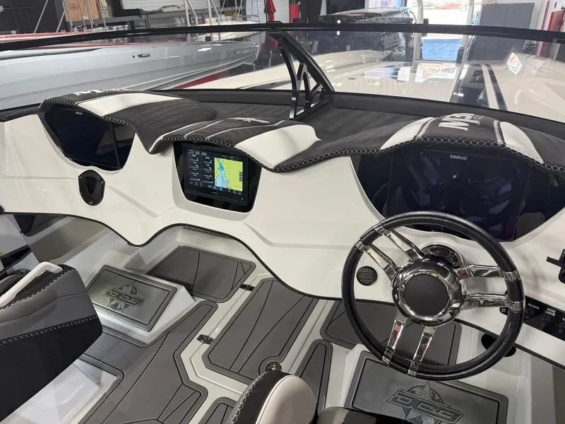 Slide: The Image of Interior of a 2016 Daves Custom Boats M31, featuring sleek dashboard and modern steering wheel. - 11