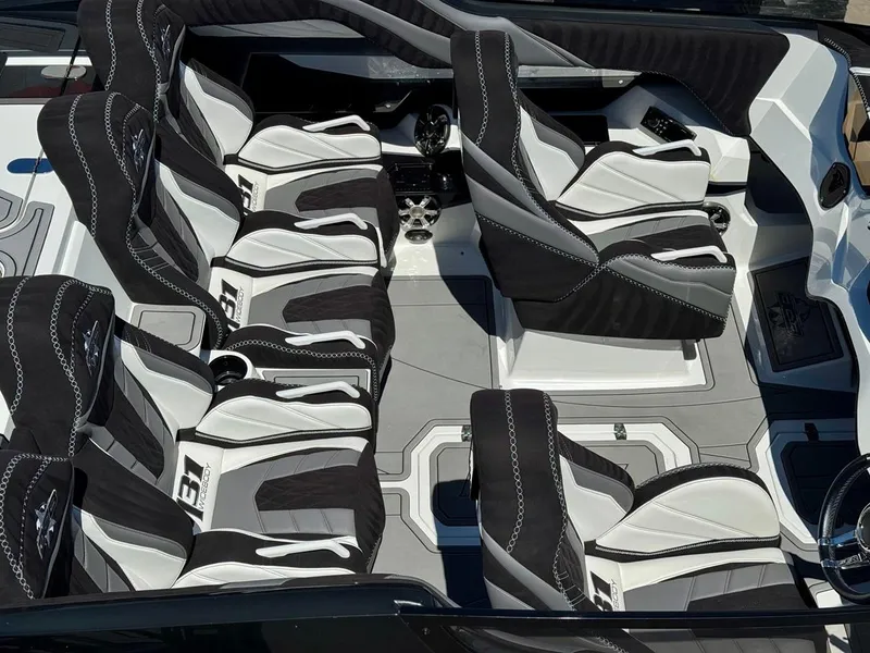 Slide: The Image of 2016 Daves Custom Boats M31 interior with sleek black and white seating arrangement. - 12
