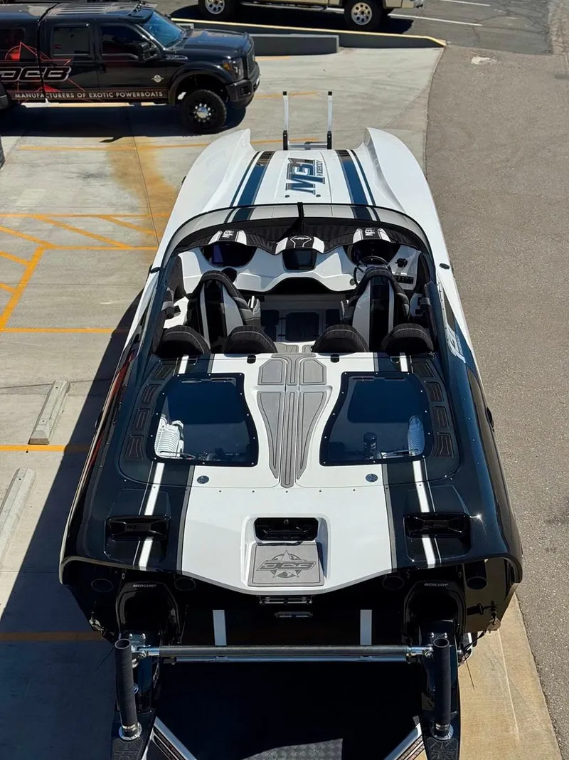Slide: The Image of 2016 Daves Custom Boats M31, sleek design, parked on concrete surface. - 2