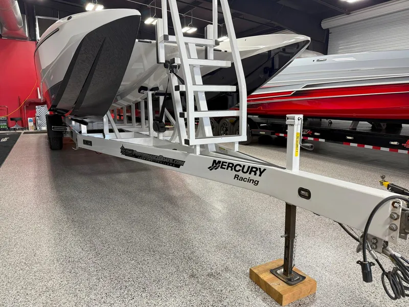 Slide: The Image of 2016 Daves Custom Boats M31 on trailer in showroom with Mercury Racing branding. - 20