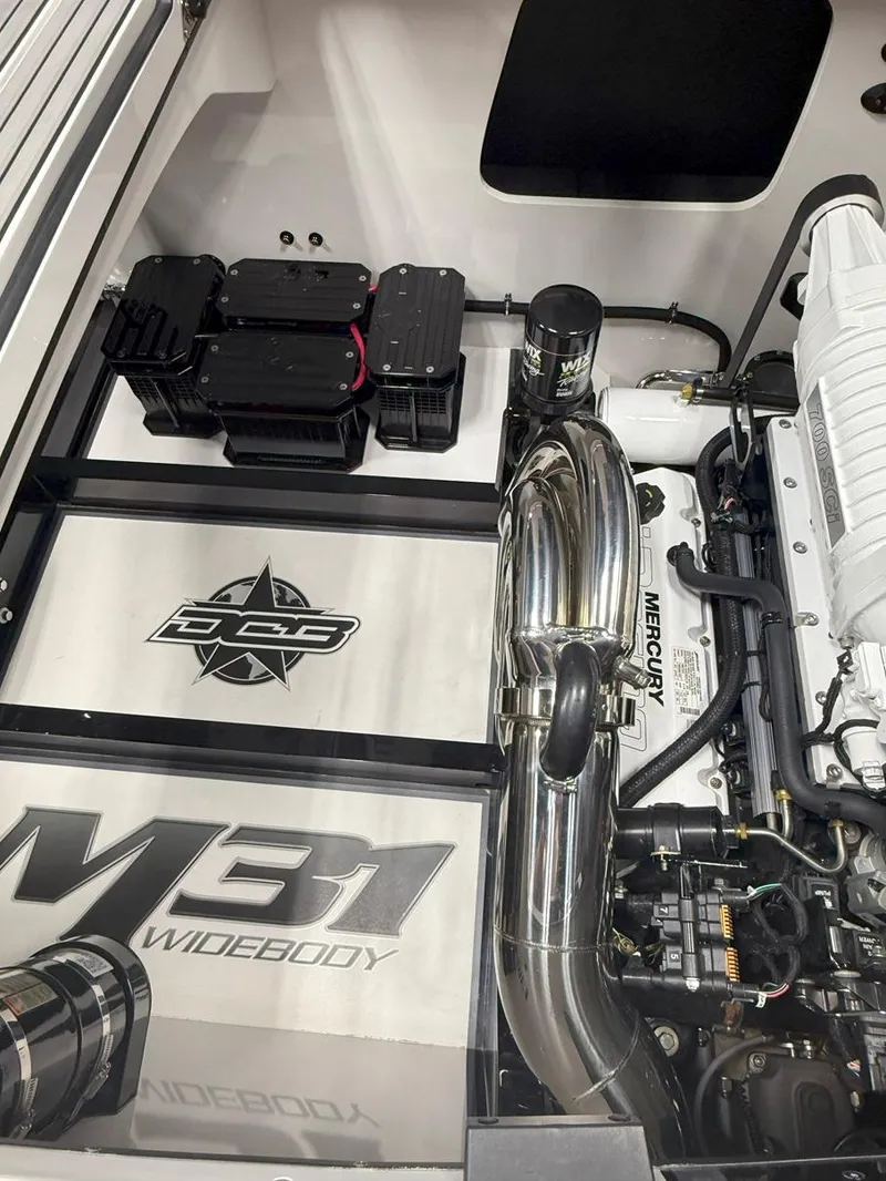 Slide: The Image of 2016 Daves Custom Boats M31 engine compartment with Mercury components and sleek design. - 23